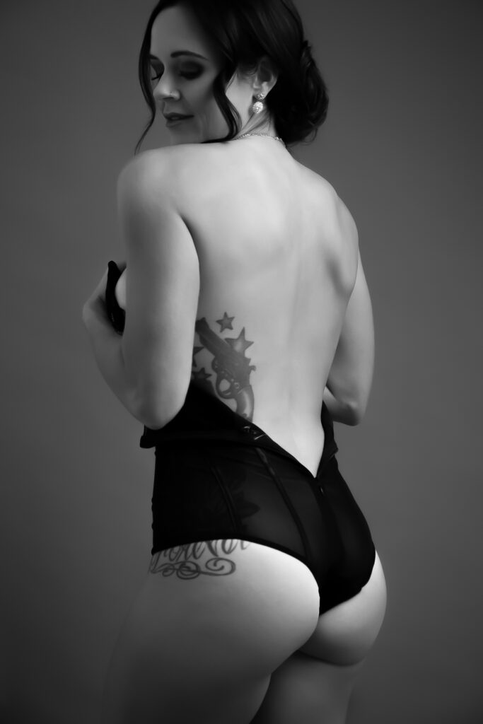 A woman wearing a black corset showing her back